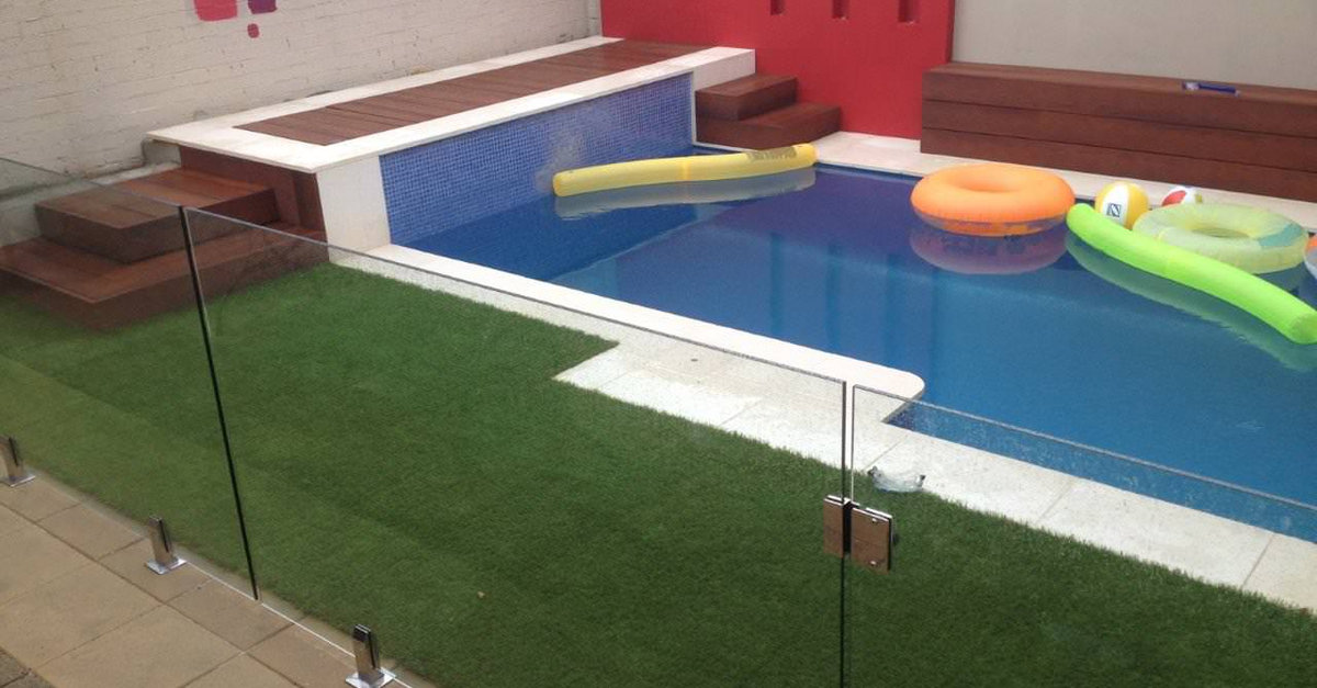 Synthetic turf around a Stanmore pool enclosure